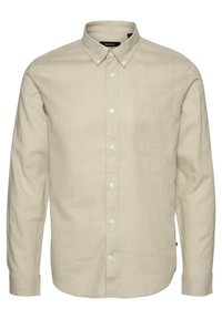 Light beige long-sleeve shirt made of textured fabric, featuring a button-down collar, front pocket, and subtle pattern, fastened with buttons.