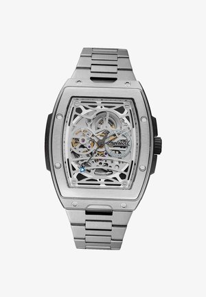 Zilverkleurig polshorloge in skeletstijl met zichtbare tandwielen, een zwarte kroon en een secondewijzer met blauwe punt, met het merk "Ingersoll" op de wijzerplaat.