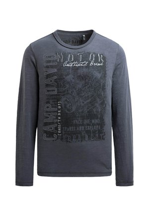 Long-sleeved, charcoal gray T-shirt with a crew neckline. Features textured fabric and printed graphic designs in black and white.