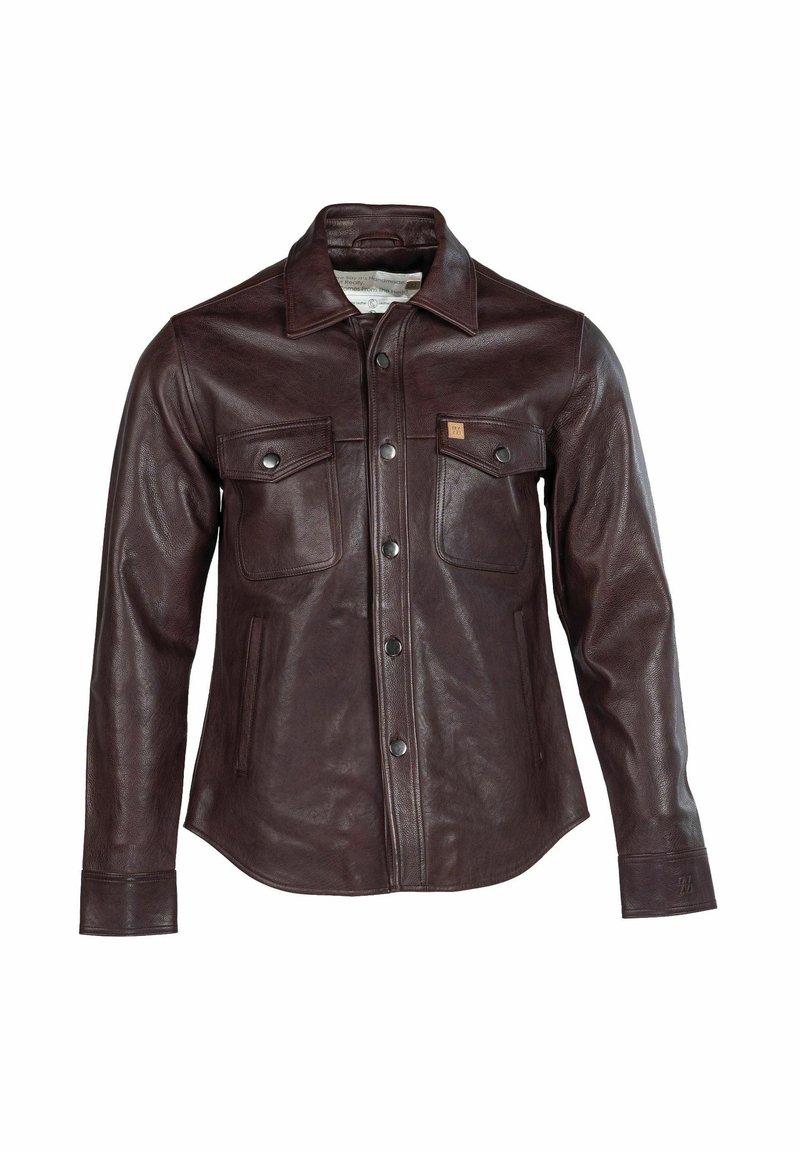 Barna bőrdzseki gombos elülső résszel, két mellzsebbel és hegyes gallérral. Sima textúra és enyhén testhezálló sziluett.