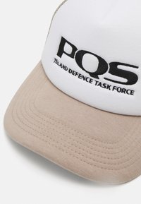 Cap with a white front panel and tan visor. Features embroidered black text reading "PQS ISLAND DEFENCE TASK FORCE." Soft fabric, structured shape.