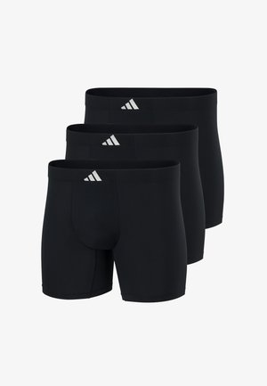 Trzy czarne bokserki męskie z małym białym logo Adidas na pasku, ułożone w sposób naprzemienny.