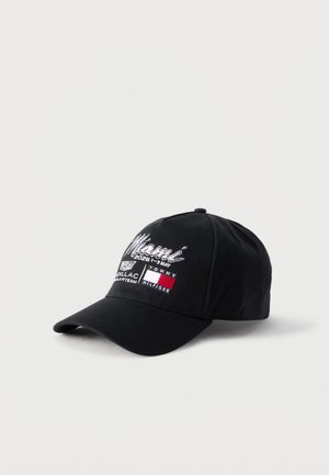 Black baseball cap with white "Miami 20261-3 May" embroidery, Cadillac logo, and Tommy Hilfiger flag on front panel.