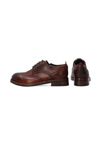 Braune Leder-Schnürschuhe mit Broguemuster, strukturierten Oberflächen und einem gestapelten Absatz. Mit runder Zehenform und Metallösen.