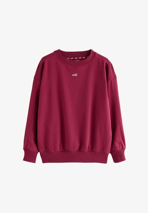 Sweat-shirt col ras-du-cou bordeaux avec poignets et bas côtelés, avec un petit texte blanc « self. » centré sur la poitrine.