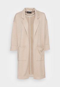 Beige long open-front cardigan with notched lapels, two front pockets, and rolled-up sleeves, hanging against a white background.