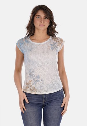Top leggero a maniche corte bianco con motivi floreali blu e marroni. Tessuto morbido con una vestibilità rilassata, scollatura rotonda e orlo leggermente curvato.