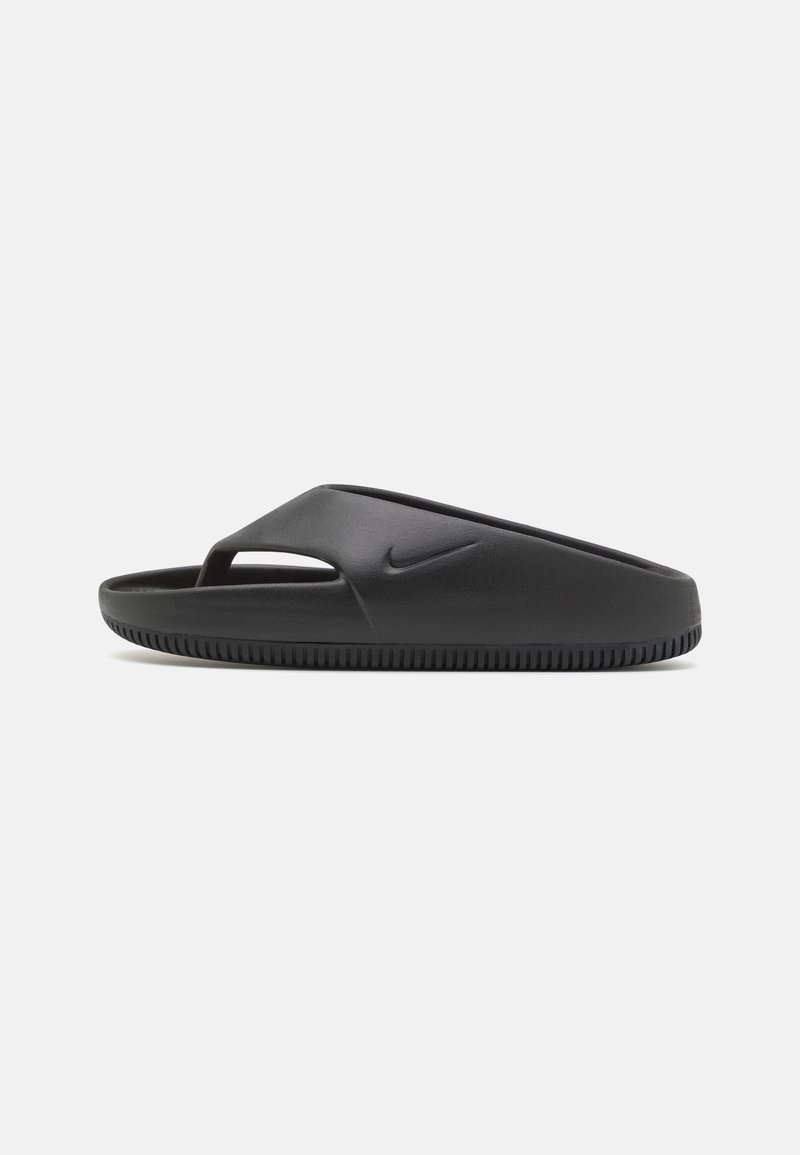 Mustat Nike-liukumissandaalit, joissa on sileä kumimateriaali, avoin varvastyyli ja tekstuuripohja pidon varmistamiseksi. Minimalistinen brändäysyksityiskohta.