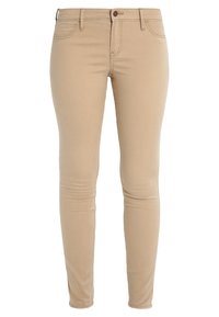 Beige slim-fit byxor med knapp- och dragkedjestängning, bälteshörn och fram- och bakfickor, presenterade mot en vit bakgrund.