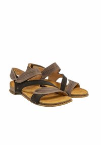 Hnědé kožené sandály s křížovými popruhy, strukturovaným svrškem a korkovou stélkou. Disponují odolnou plochou podrážkou s jemným švem.