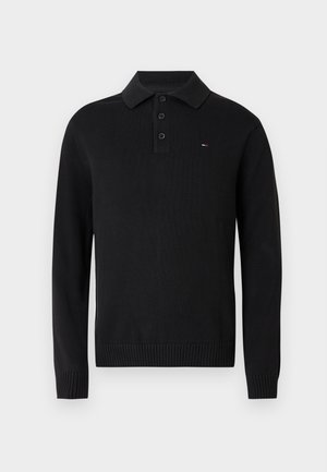 Pulover polo negru tricotat, cu guler și nasturi cu închidere cu trei capse, manșete plisate. Prezintă un logo mic pe piept.