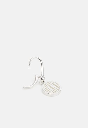 Silver hoop earring featuring a circular pendant with a striped pattern. Smooth metal surface, polished finish, and secure clasp design.