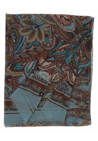 Sciarpa leggera con motivi floreali e paisley in blu, marrone e crema. I bordi presentano una texture frangiata. Il tessuto è leggero e morbido.
