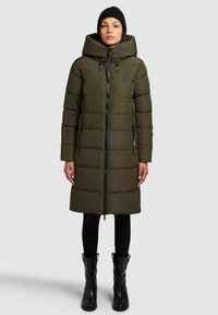 Olivengrøn puffjakke med høj krave, lynlås foran og to sidelommer. Har en knælang udformning og et tekstureret quiltet mønster.