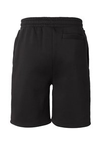 Shorts en coton noirs avec ceinture élastique et une poche arrière unique sur le côté droit, vus de dos.