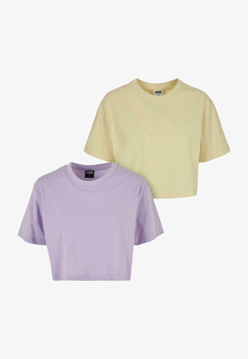Kaksi lyhythihaista cropped t-paitaa: yksipastelli keltainen ja toinen pastelli laventeli. Valmistettu pehmeästä puuvillasta, ja niissä on pyöreä kaula-aukko.