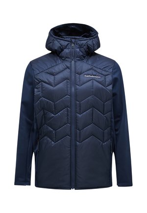 Giacca a vento blu navy con parte frontale imbottita caratterizzata da un motivo a zigzag, chiusura con zip e maniche in materiale elasticizzato.