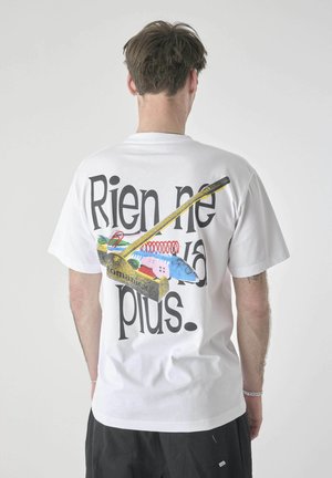 White cotton t-shirt featuring a colorful graphic on the back, including a yellow handle, text "Rien ne va plus," and various playful illustrations.