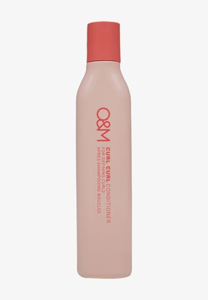 Tall, slim beige bottle with coral cap labeled O&M Curl Curl Conditioner for defining curls.