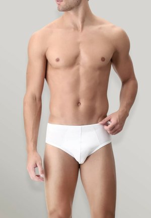 Slip in cotone bianco con una cintura elastica. Design semplice, forma aderente e texture liscia, adatti per l'uso quotidiano.