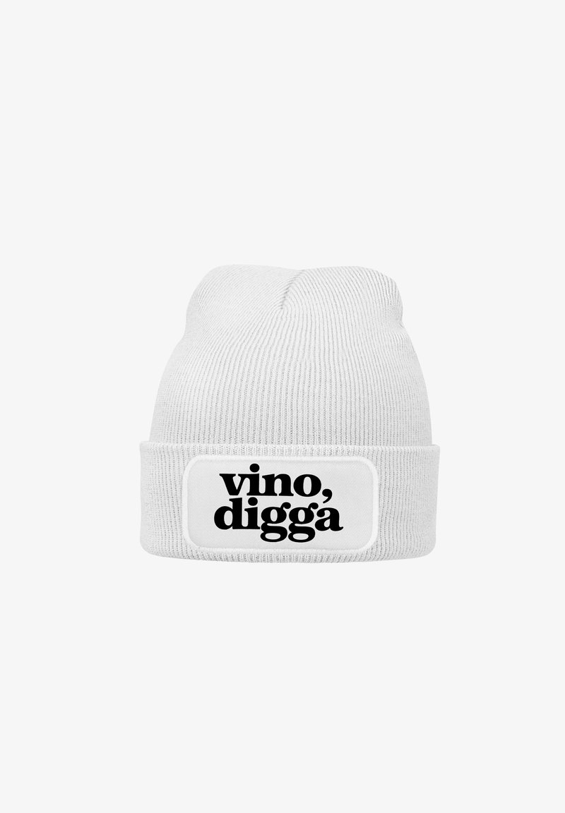 White knit beanie with a ribbed texture and a folded cuff. Features a rectangular patch with the text "vino, digga" in bold black font.