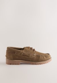 Brown suede boat shoe with a rounded toe, stitched detailing, and two metal eyelets for laces. Rubber sole with textured grip.