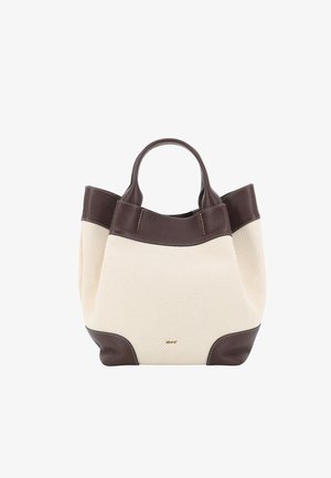 Cream fabric tote bag with dark brown leather handles, trim, and bottom corners, featuring a small gold brand logo on the front.
