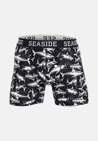 Boxer da uomo neri con un motivo di squali bianchi, vita elastica con etichetta "SEASIDE" e una trama di tessuto morbido.