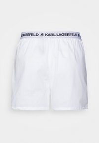 Biele bavlnené šortky s čiernym pásom, na ktorom je logo "KARL LAGERFELD". Jednoduchý dizajn bez ďalších vzorov alebo akcentov.