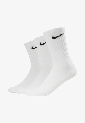 Three pairs of white cotton crew socks. Ribbed texture with a black Nike logo on each sock. Standard sock shape, suitable for casual wear.