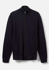 Strick-Zipfeljacke in Dunkelblau. Mit hohem Kragen und zwei seitlichen Taschen. Rippstruktur mit schmalem Saum und Bündchen.
