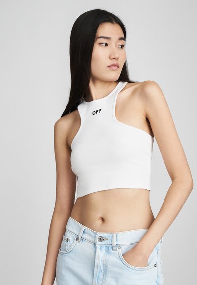 White ribbed crop top with a high neckline, featuring "OFF" printed in black on the front. Paired with light blue denim shorts.