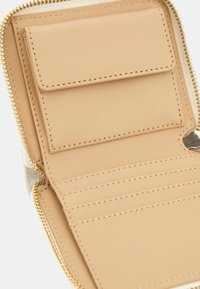 Beige leather wallet with a zipper, featuring a card slot section, a flat pocket, and smooth texture with neat stitching details.