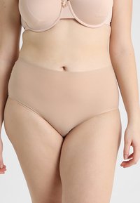High-waisted beige underwear made from smooth fabric with a seamless design and gentle waistbands for comfort.