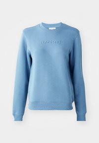 Sudadera azul claro con cuello redondo acanalado y mangas largas. Presenta el logotipo" LACOSTE "embosado en la parte frontal y una textura de tela.
