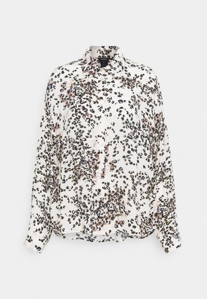 Long-sleeved, button-up shirt in lightweight fabric featuring a white base with a black and brown leopard print pattern. Standard collar and curved hem.