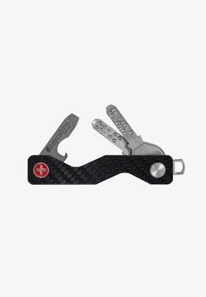 Multi-tool with a black carbon fiber handle, stainless steel tools, including a knife and keys, featuring a silver accent and red logo.