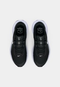 Μαύρα αθλητικά παπούτσια με επάνω μέρος από διχτυωτό υλικό, στρογγυλή μύτη και διακριτό άσπρο λογότυπο. Διαθέτουν γκρι λεπτομέρειες και επενδεδυμένο κολάρο για άνεση.