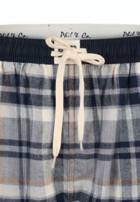 Katoenen geruite lounge shorts in marineblauw, grijs en crème, met een elastische tailleband en een crèmekleurige trekkoord, voorzien van een opvallend visgraatmotief.