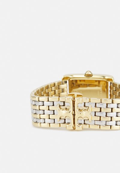 Gold-tone watch with a woven metal band featuring gold and silver links. Rectangular case with a polished surface and raised crown.