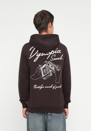 Dark brown hoodie featuring white graphic design on the back, depicting hands holding a cassette player, with text below.