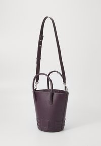 Dark purple leather bucket bag with two short handles and a long adjustable strap, featuring embossed branding on the front.