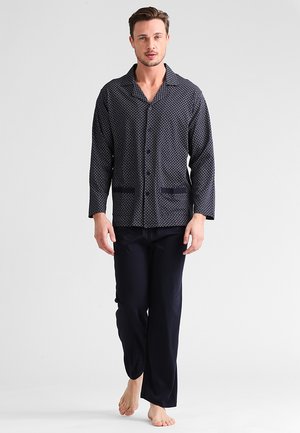Men's pajama set featuring a navy patterned button-up jacket with long sleeves and two front pockets, paired with matching loose-fit pants.