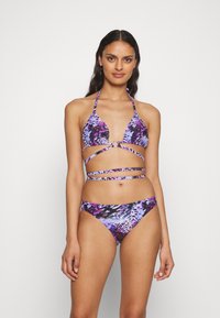 Purple and black bikini with a leopard print pattern; the top features triangle cups and adjustable straps, and the bottom is mid-rise.