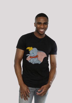 Black t-shirt featuring a colorful illustration of Dumbo the elephant, with large ears and a yellow hat, on a soft cotton fabric.