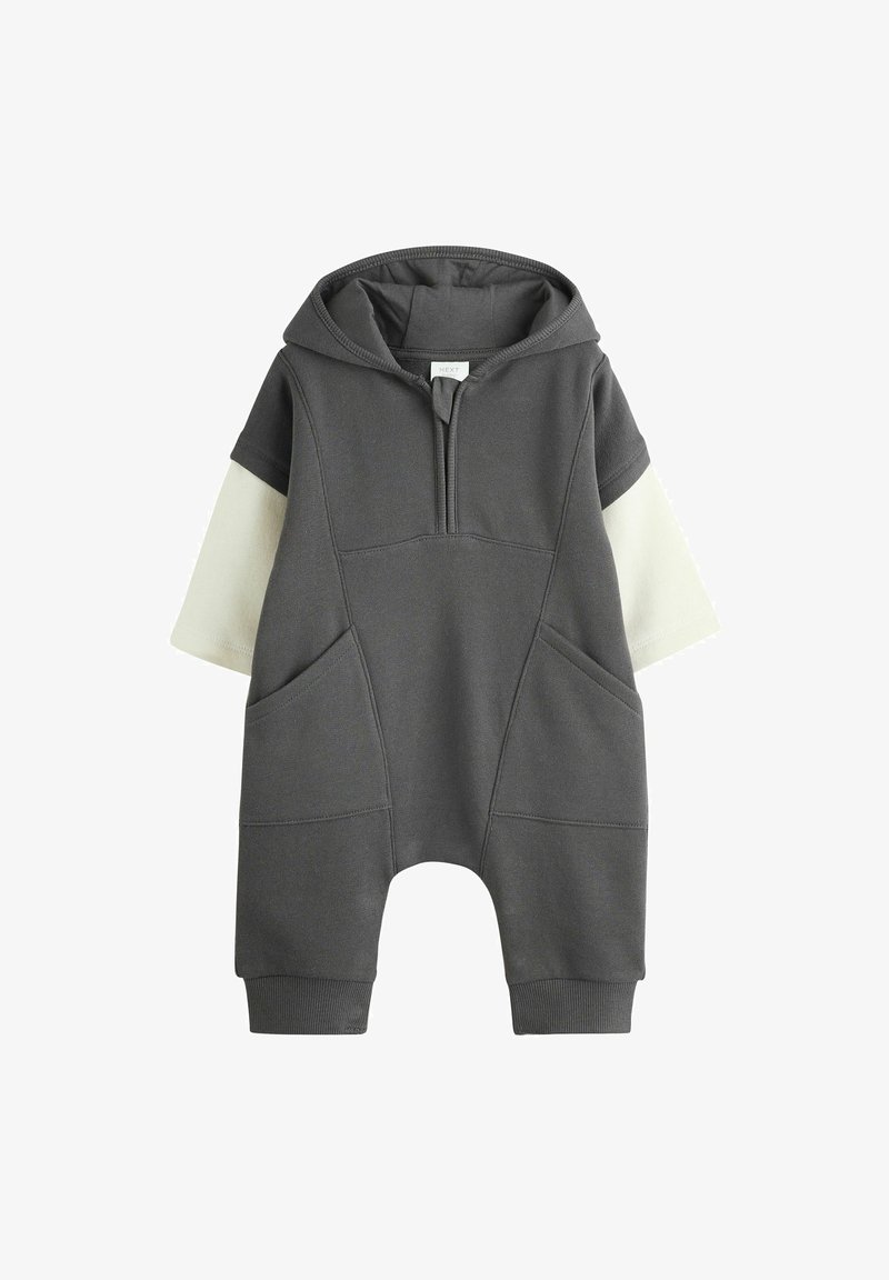 Dark gray baby jumpsuit with attached hood, short cream sleeves, front zipper, and large front pockets.