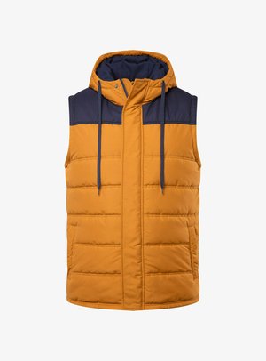 Polstret vest i gylden orange med marineblå detaljer, en hætte, frontlynlås og to sidelommer. Har horisontale quiltede sektioner.