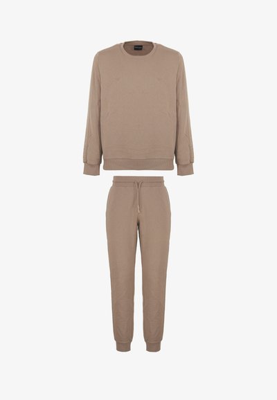 Set di felpa e pantaloni tuta beige, con colletto rotondo, polsini a costine e vita elasticizzata con coulisse sui pantaloni.