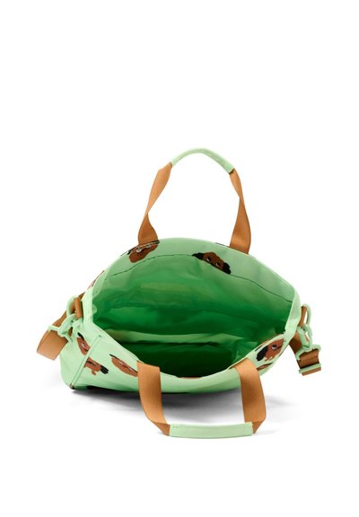 Borsa a mano verde chiaro con manici marroni e stampe di volti di cane, mostrata aperta con un interno spazioso e tracolla regolabile sul lato.