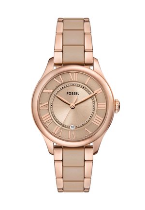 Montre en or rose avec un boîtier rond, bracelet en silicone beige, chiffres romains sur un cadran texturé couleur or, et un affichage de la date à 6 heures.